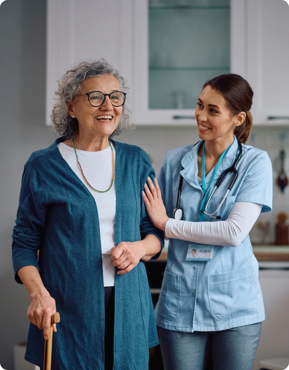 Elderly woman and nurse smiling together