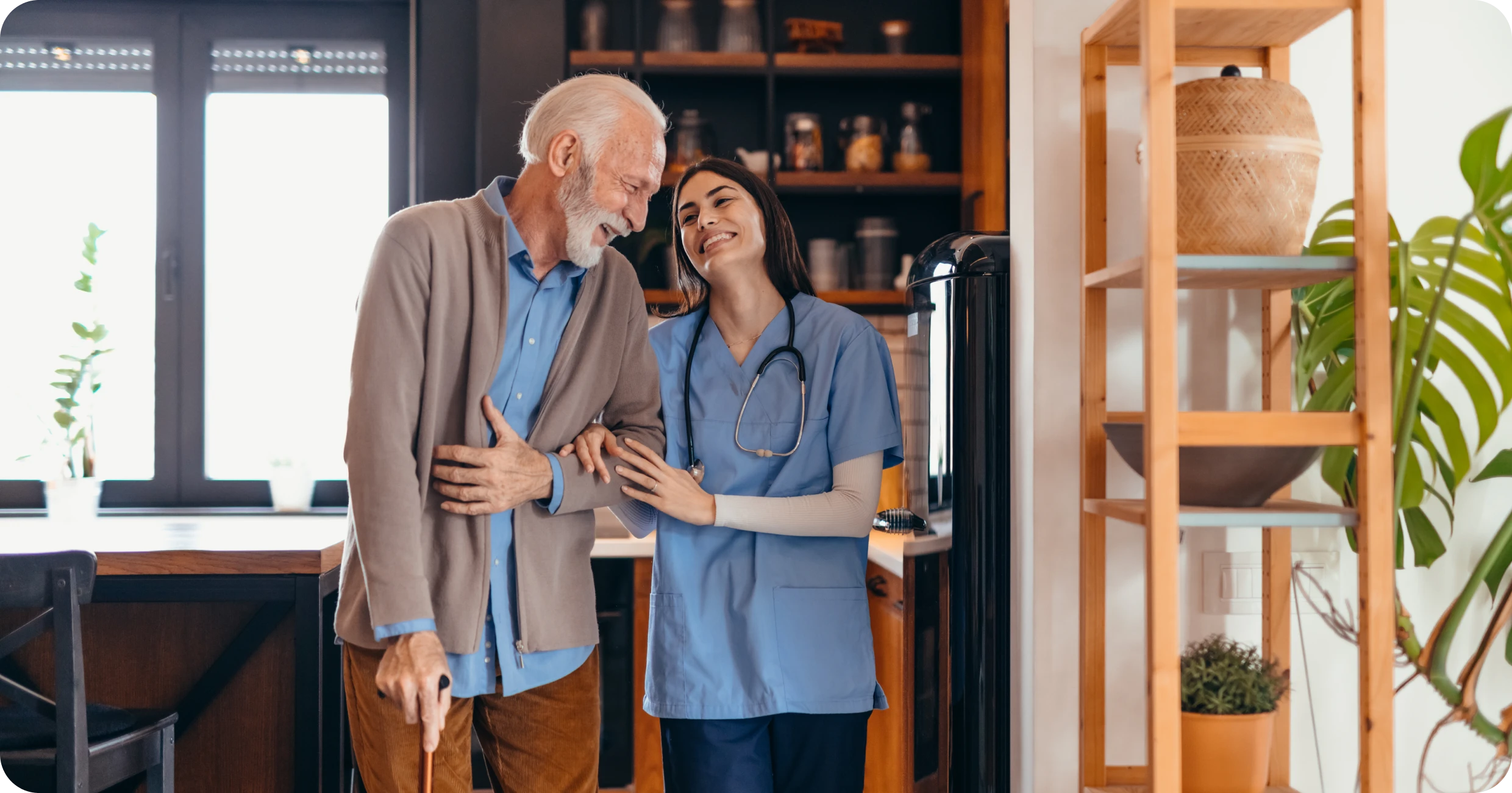 Elderly man with nurse in kitchen