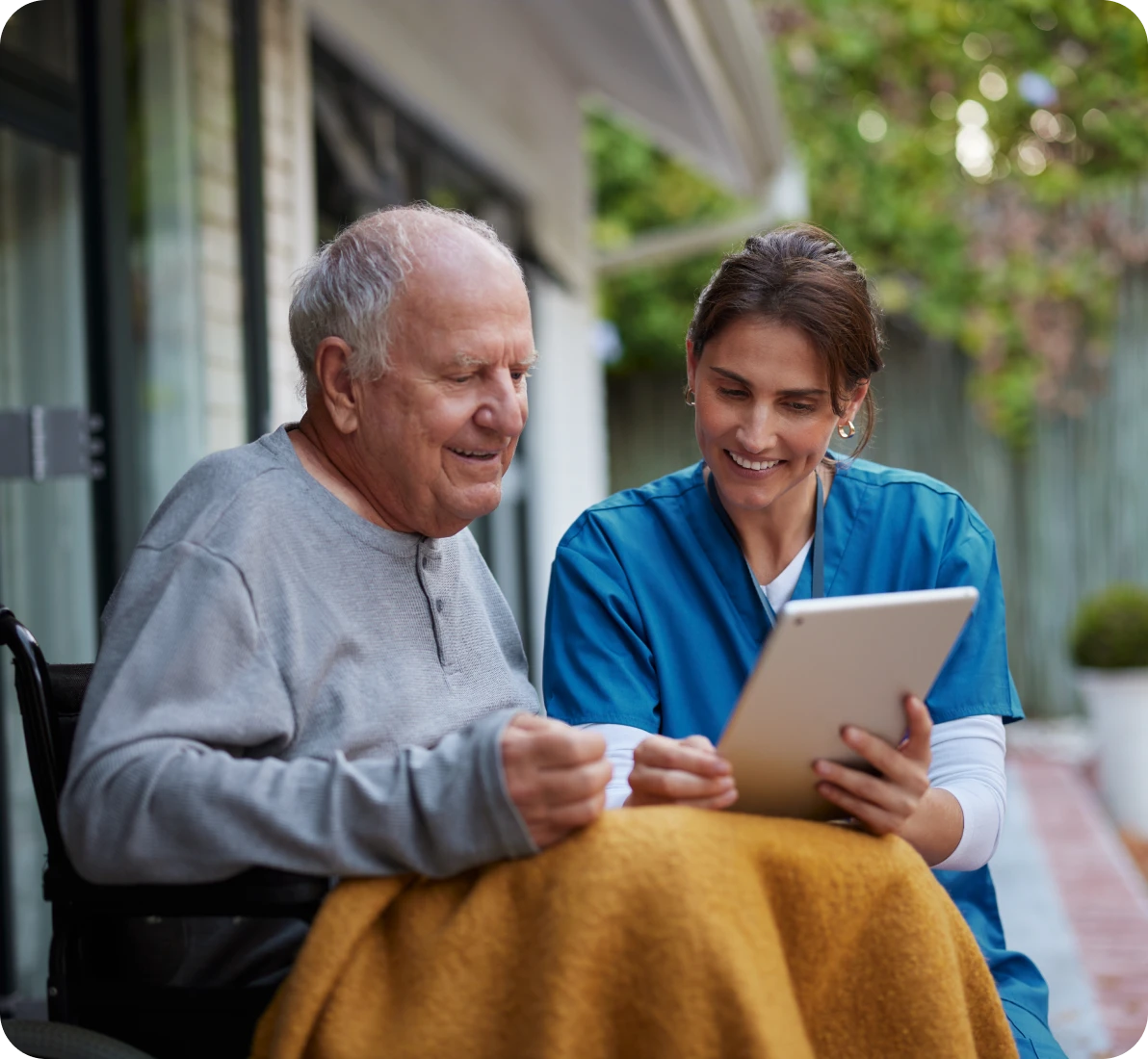 Senior man and nurse smiling together