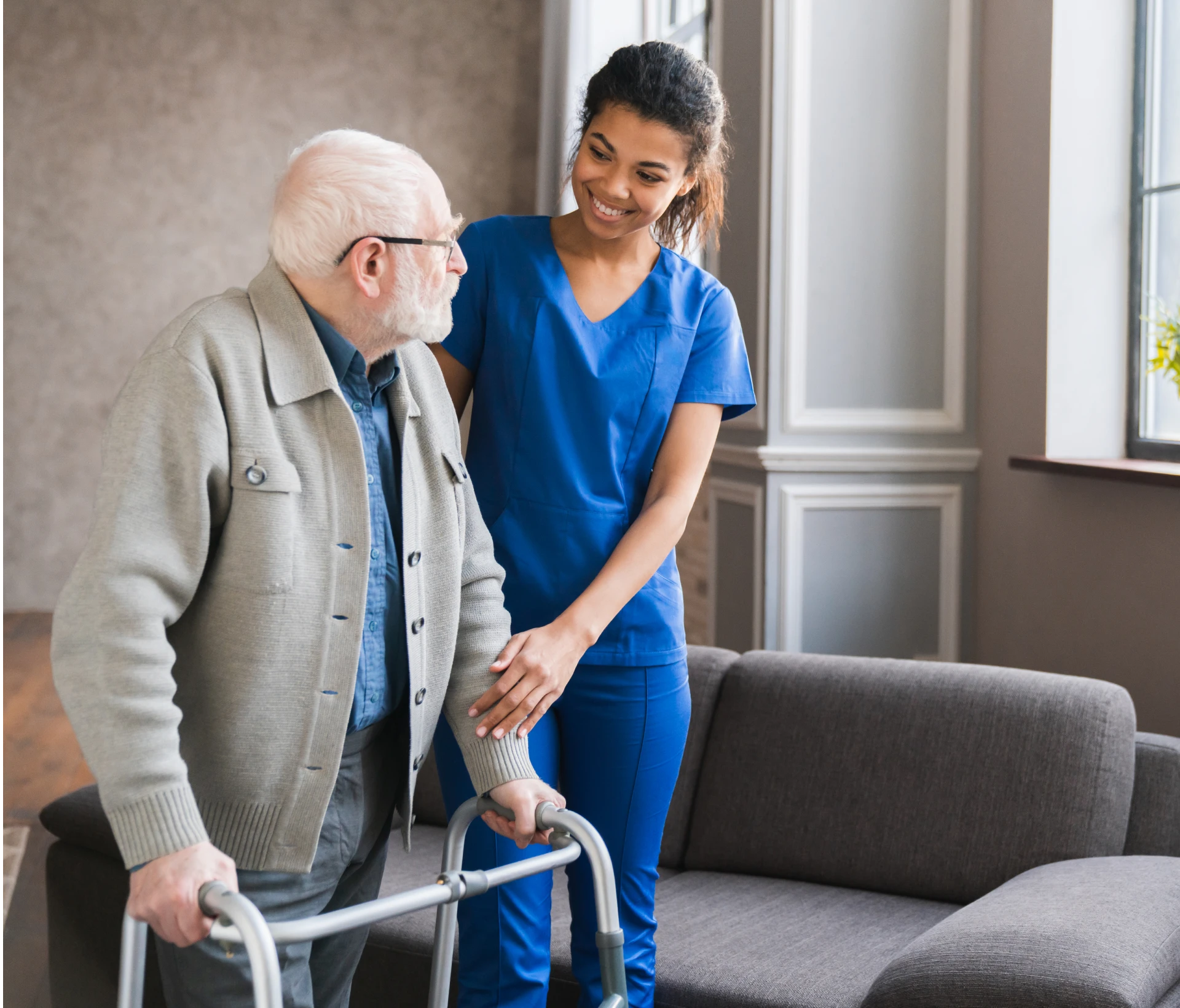 Caregiver supporting senior man using walker